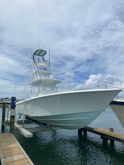 Nauty C Bouys Yacht Photos Pics 2012 Contender 39 ST boat docked under a cloudy sky.