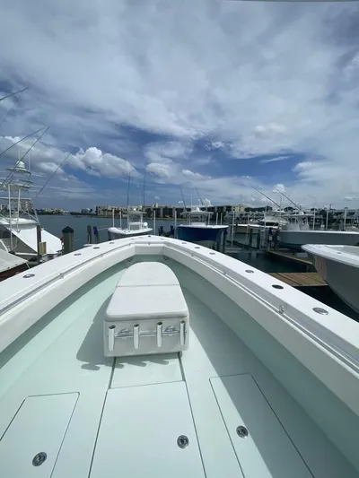 Nauty C Bouys Yacht Photos Pics 2012 Contender 39 ST boat docked under a partly cloudy sky.