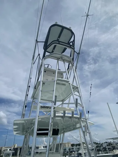 Nauty C Bouys Yacht Photos Pics 2012 Contender 39 ST boat tower against a cloudy sky.