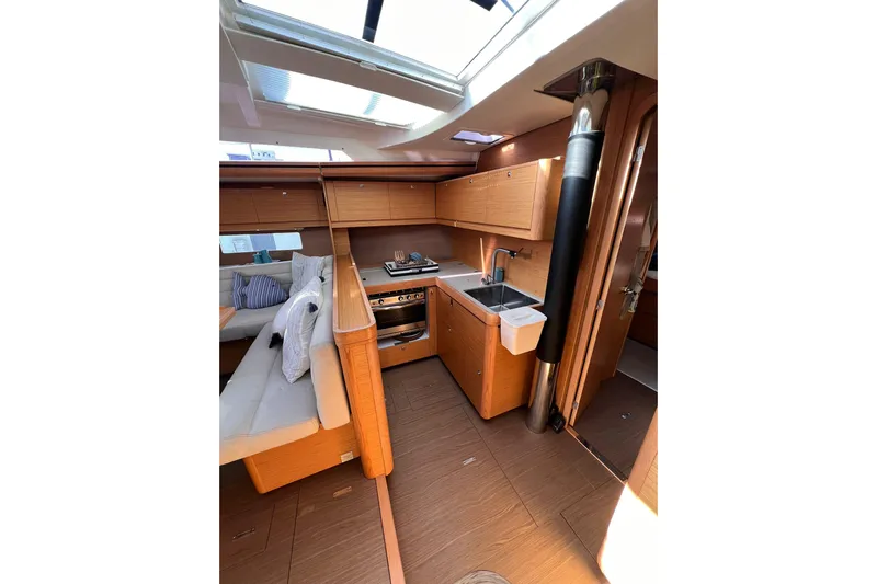 Cum Laude Yacht Photos Pics Interior of 2017 Dufour 512 Grand Large yacht, featuring modern kitchen and seating area.