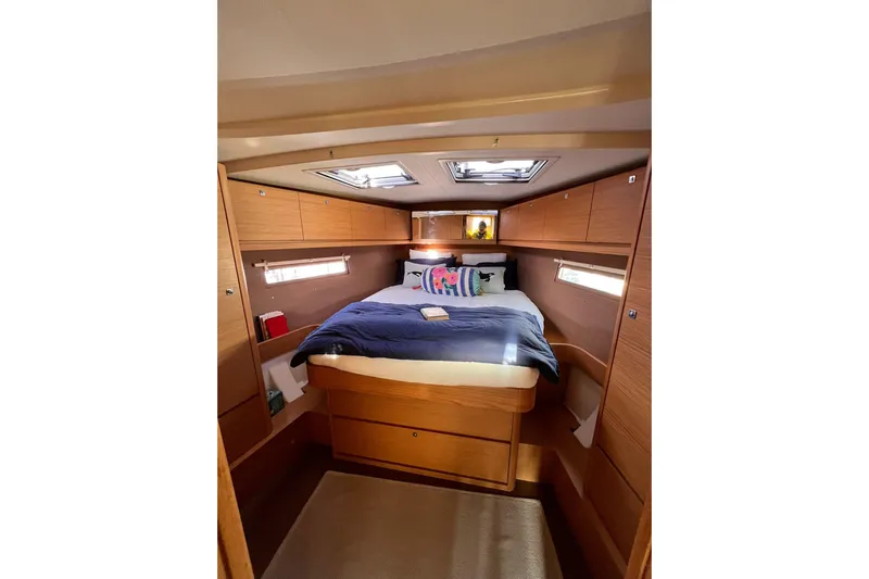 Cum Laude Yacht Photos Pics Cozy cabin interior of 2017 Dufour 512 Grand Large yacht with skylights and wooden finish.