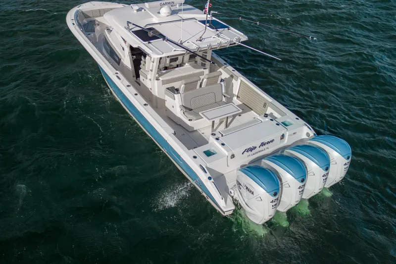  Yacht Photos Pics 2022 Pursuit S 428 Sport boat with four Yamaha engines on the water.