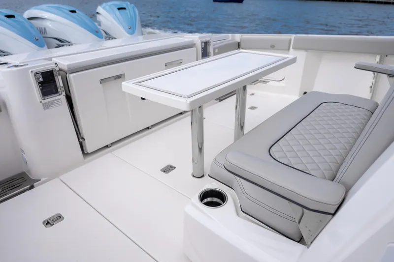  Yacht Photos Pics 2022 Pursuit S 428 Sport boat interior with seating and table, featuring Yamaha engines.
