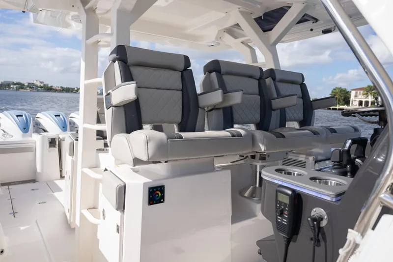  Yacht Photos Pics 2022 Pursuit S 428 Sport boat interior with luxurious seating and modern controls.