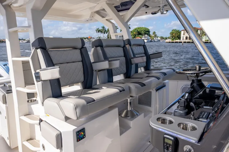  Yacht Photos Pics 2022 Pursuit S 428 Sport boat interior with luxurious seating and control panel.