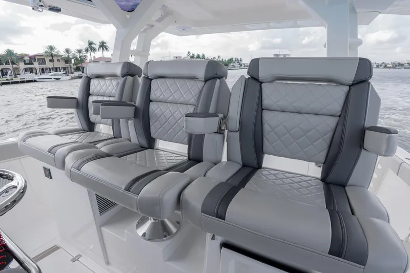  Yacht Photos Pics Luxurious seating on 2022 Pursuit S 428 Sport boat, featuring quilted gray upholstery.