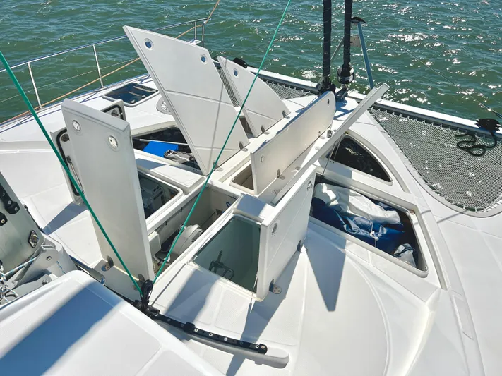 Fido Yacht Photos Pics 2017 Xquisite Yachts X5 deck with open storage compartments on the water.