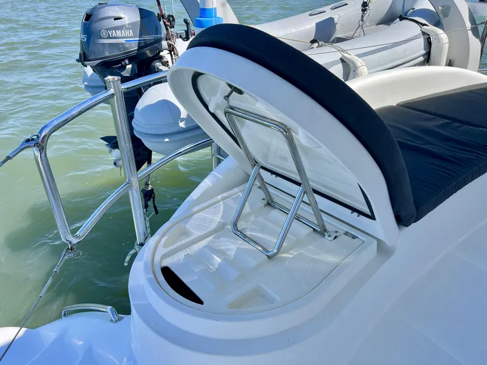Fido Yacht Photos Pics Xquisite Yachts X5 2017 with open storage compartment and Yamaha motor in water.