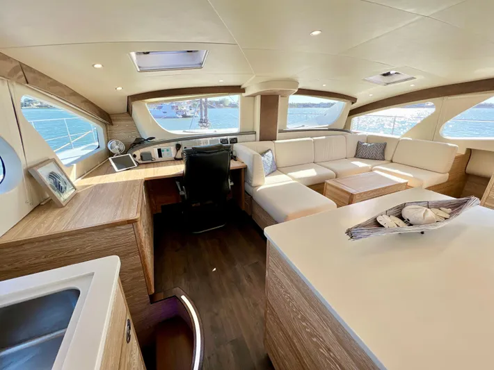 Fido Yacht Photos Pics Luxurious interior of 2017 Xquisite Yachts X5 with modern seating and panoramic windows.