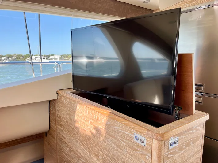 Fido Yacht Photos Pics Luxury interior of 2017 Xquisite Yachts X5 with pop-up TV and scenic window view.