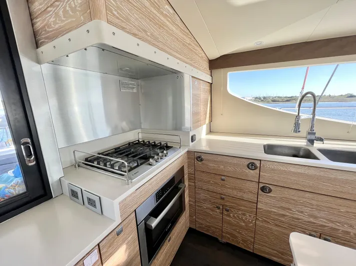 Fido Yacht Photos Pics Modern kitchen interior of 2017 Xquisite Yachts X5 with stove, oven, and sink.
