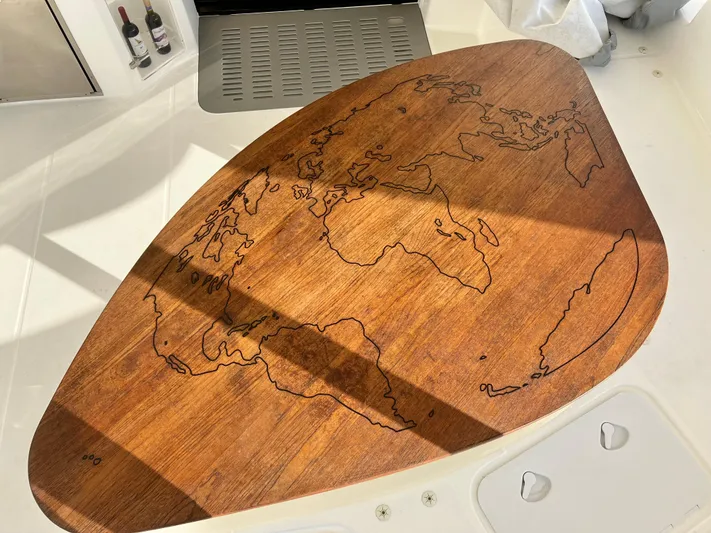 Fido Yacht Photos Pics Wooden table with world map engraving on 2017 Xquisite Yachts X5.