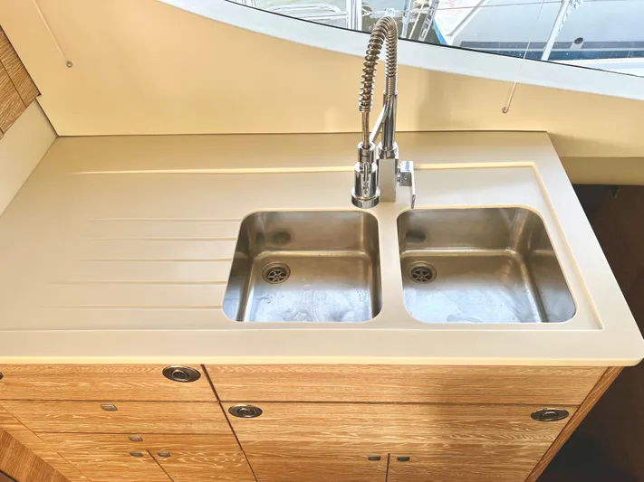 Fido Yacht Photos Pics Modern kitchen sink on 2017 Xquisite Yachts X5, featuring dual basins and sleek faucet.
