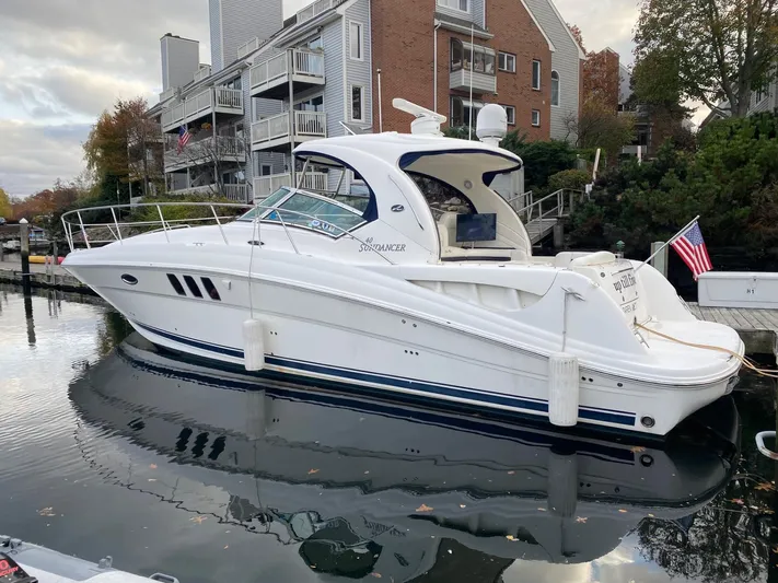  Yacht Photos Pics 2007 Sea Ray 40 Sundancer yacht docked near waterfront homes, reflecting in calm water.
