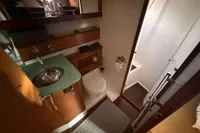 Bathroom interior of 2008 Beneteau Swift Trawler 52 with sink, toilet, and shower.