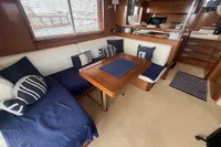 Luxurious interior of 2008 Beneteau Swift Trawler 52 with cozy seating and nautical decor.