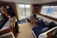 Luxurious interior of 2008 Beneteau Swift Trawler 52 with cozy seating and elegant decor.