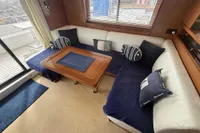Interior of 2008 Beneteau Swift Trawler 52 with cozy seating and nautical decor.