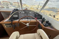 Helm of 2008 Beneteau Swift Trawler 52 with navigation equipment and steering wheel.