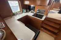 Galley kitchen in 2008 Beneteau Swift Trawler 52 with wood cabinetry and modern appliances.