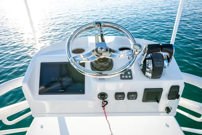  Yacht Photos Pics Steering console of 2021 Yellowfin 42 boat with Garmin display on calm water.