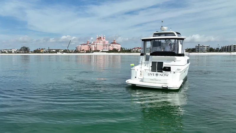 Live Now Yacht Photos Pics 2006 Carver 444 Cockpit Motor Yacht on calm water with scenic coastal backdrop.