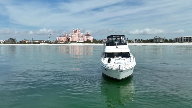 Live Now Yacht Photos Pics 2006 Carver 444 Cockpit Motor Yacht on calm water with scenic shoreline backdrop.