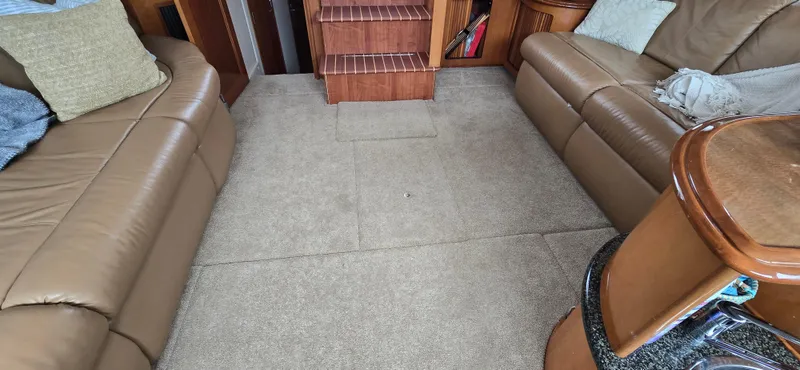 Live Now Yacht Photos Pics Interior of 2006 Carver 44CPMY yacht with beige leather seating and carpeted floor.