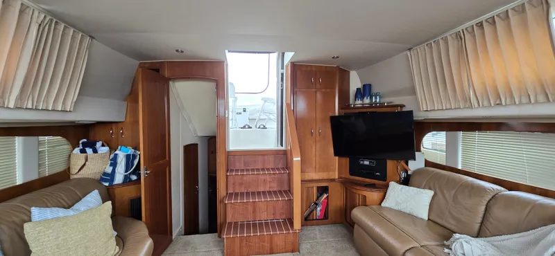 Live Now Yacht Photos Pics Interior of 2006 Carver 44CPMY yacht with cozy seating and wooden cabinetry.