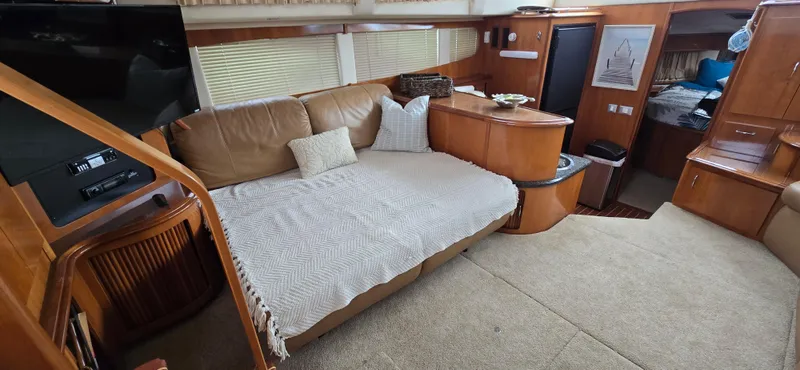 Live Now Yacht Photos Pics Interior of 2006 Carver 44CPMY yacht with cozy seating and elegant wood finishes.