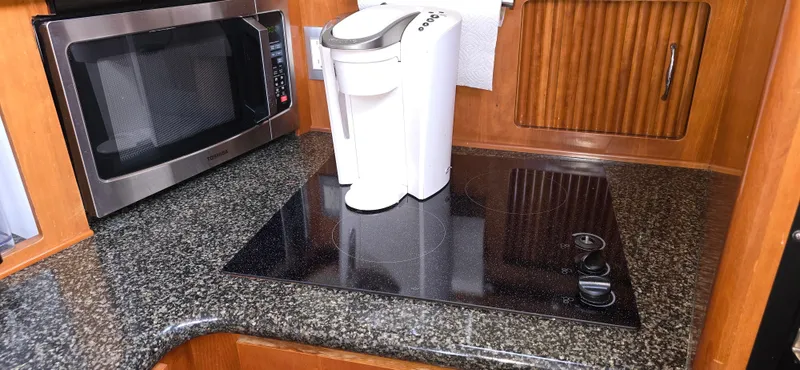 Live Now Yacht Photos Pics 2006 Carver 44CPMY yacht kitchen with microwave, coffee maker, and stovetop.