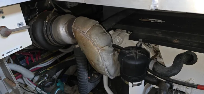 Live Now Yacht Photos Pics Engine compartment of a 2006 Carver 44CPMY yacht, showing exhaust and piping.
