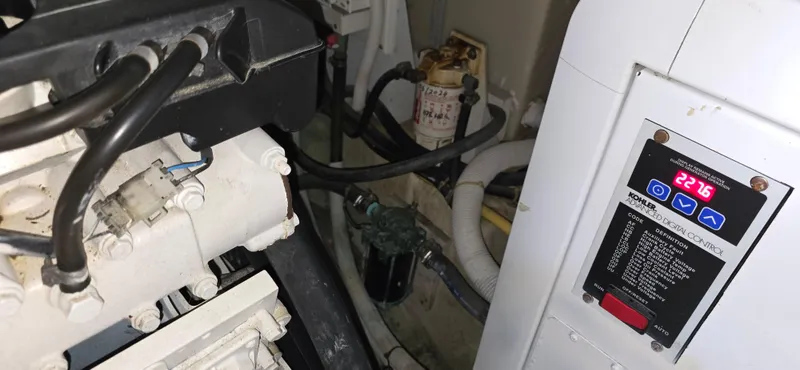 Live Now Yacht Photos Pics Engine room of a 2006 Carver 44CPMY yacht, showing machinery and control panel.