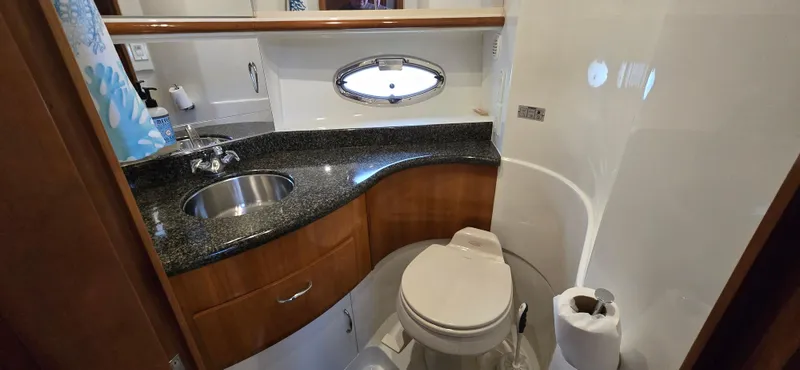 Live Now Yacht Photos Pics Luxurious bathroom in 2006 Carver 44CPMY yacht with granite countertop and modern fixtures.