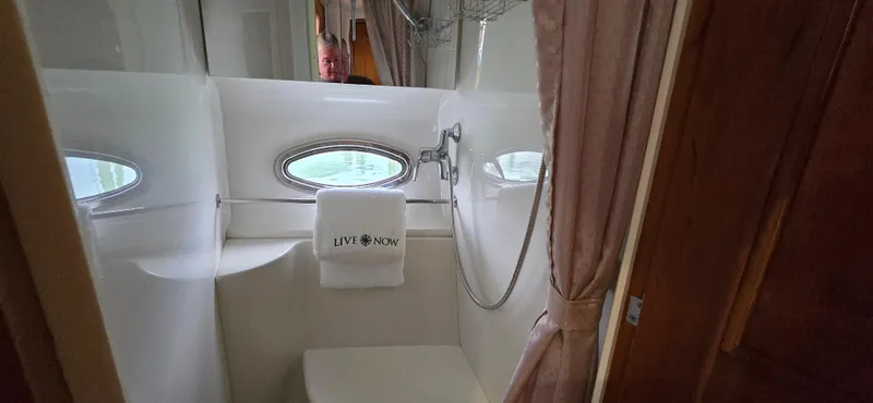 Live Now Yacht Photos Pics Bathroom interior of 2006 Carver 44CPMY yacht with shower and towel.