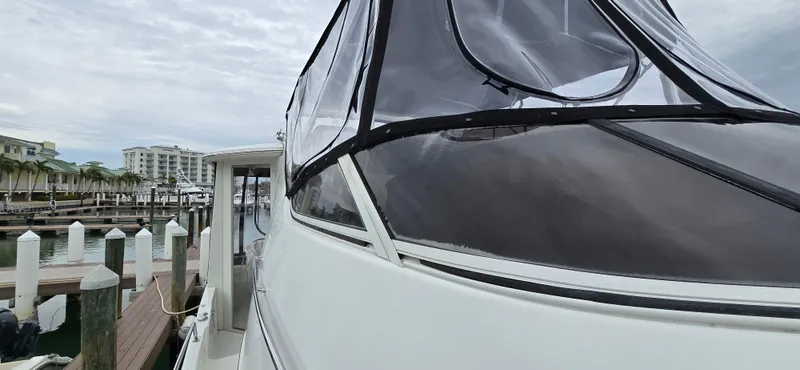 Live Now Yacht Photos Pics 2006 Carver 44CPMY yacht docked at marina with clear canopy.