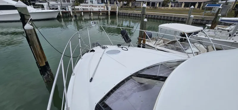 Live Now Yacht Photos Pics 2006 Carver 44CPMY yacht docked at marina, view of bow and surrounding boats.