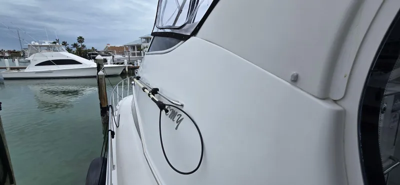 Live Now Yacht Photos Pics 2006 Carver 44CPMY yacht docked at marina, side view with water and boats.