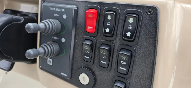 Live Now Yacht Photos Pics Control panel of a 2006 Carver 44CPMY yacht with thruster and switch buttons.