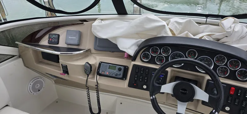 Live Now Yacht Photos Pics 2006 Carver 44CPMY helm with gauges, steering wheel, and navigation equipment.