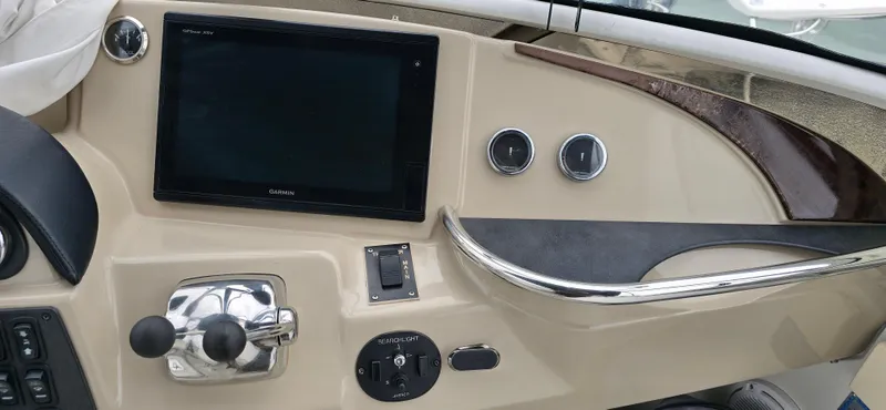 Live Now Yacht Photos Pics Control panel of a 2006 Carver 44CPMY yacht with navigation screen and controls.