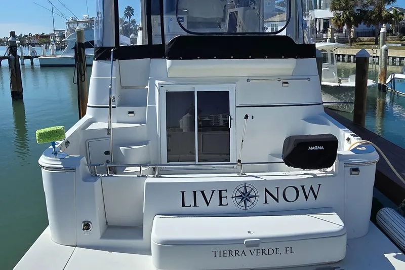 Live Now Yacht Photos Pics 2006 Carver 44CPMY yacht docked in Tierra Verde, FL, with "Live Now" text on stern.