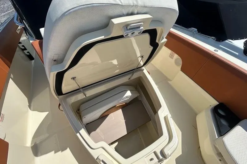  Yacht Photos Pics 2024 Capoforte FX270 boat seat storage compartment open, showcasing interior space.