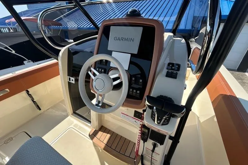  Yacht Photos Pics 2024 Capoforte FX270 boat cockpit with Garmin navigation system and modern steering wheel.