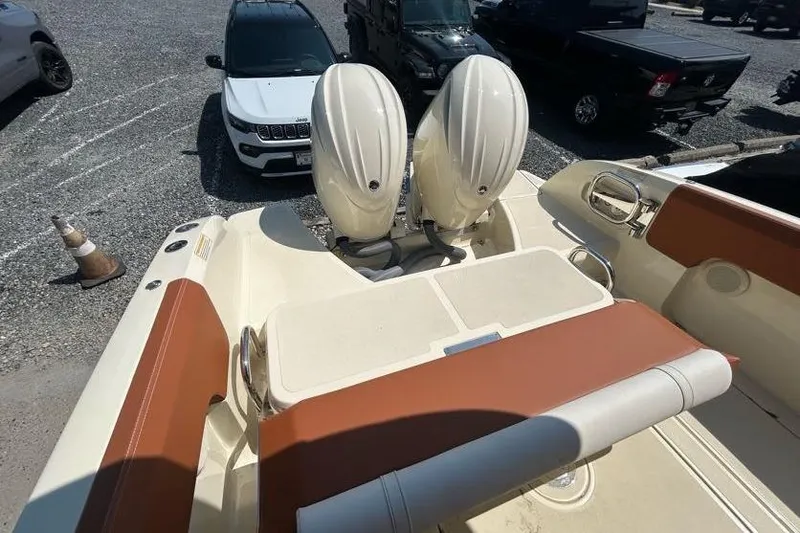  Yacht Photos Pics 2024 Capoforte FX270 boat with dual engines, parked near vehicles.