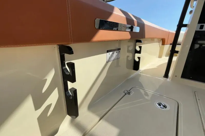  Yacht Photos Pics 2024 Capoforte FX270 boat interior with tan upholstery and storage compartments.
