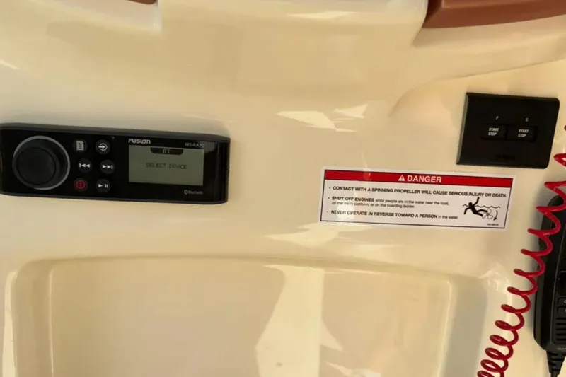  Yacht Photos Pics 2024 Capoforte FX270 dashboard with Fusion stereo, safety warning, and control panel.