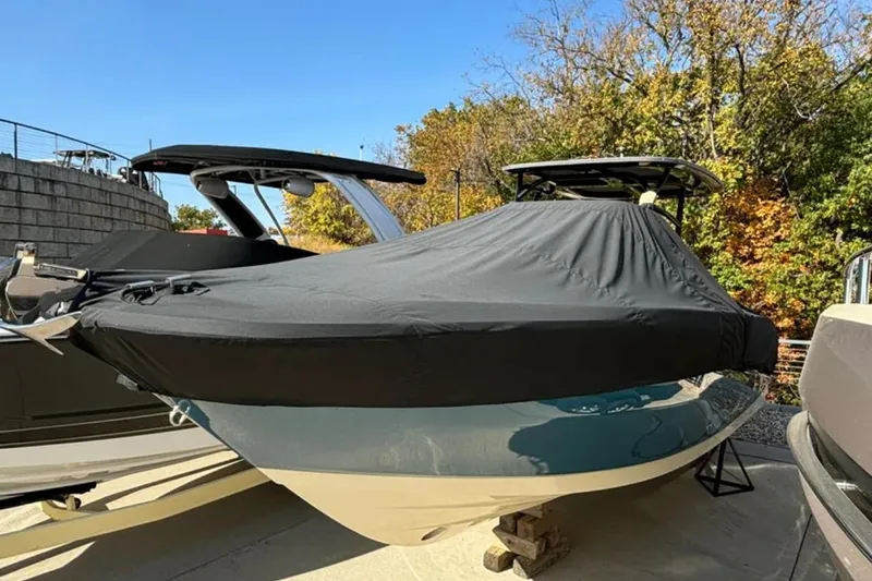  Yacht Photos Pics 2024 Capoforte FX270 boat covered, parked outdoors with trees in the background.
