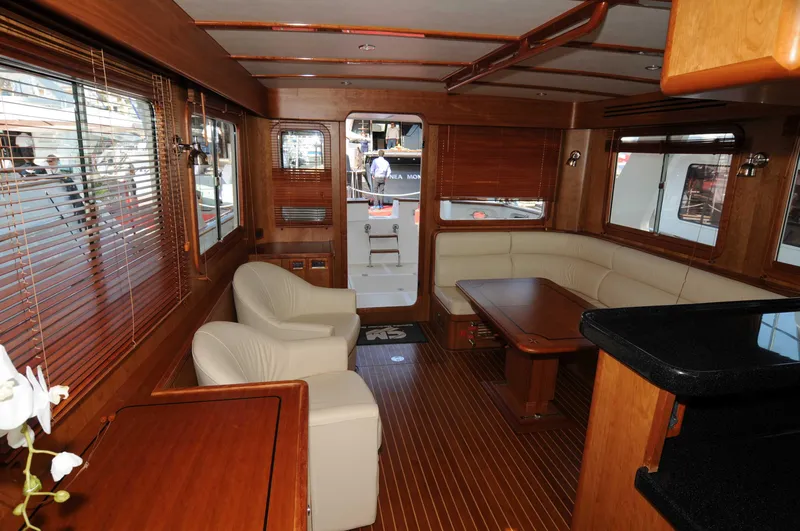  Yacht Photos Pics Luxurious interior of 2026 Selene 54 yacht with wooden finishes and comfortable seating.