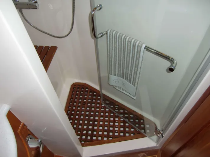  Yacht Photos Pics Shower area in 2026 Selene 54 yacht with wooden floor and towel rack.